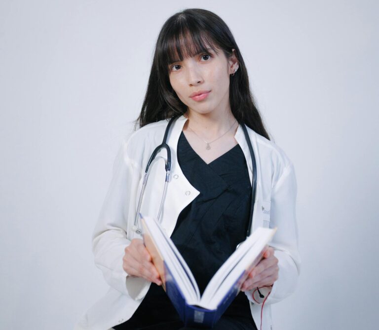 A young medical student studies with a stethoscope, emphasizing education.